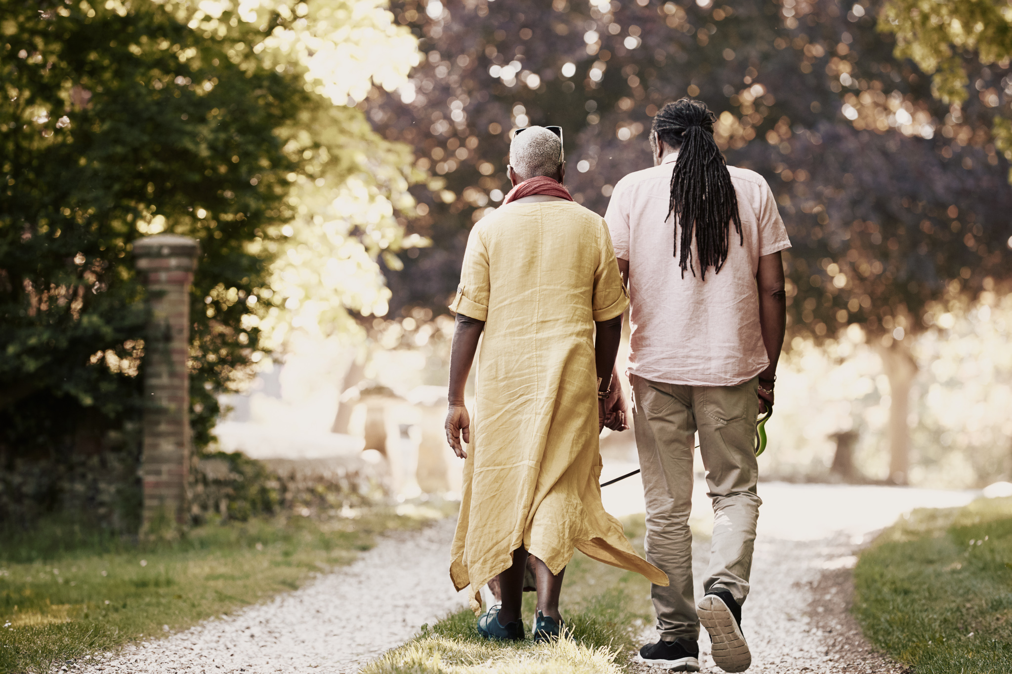 Senior couple walking their bulldog in the countryside