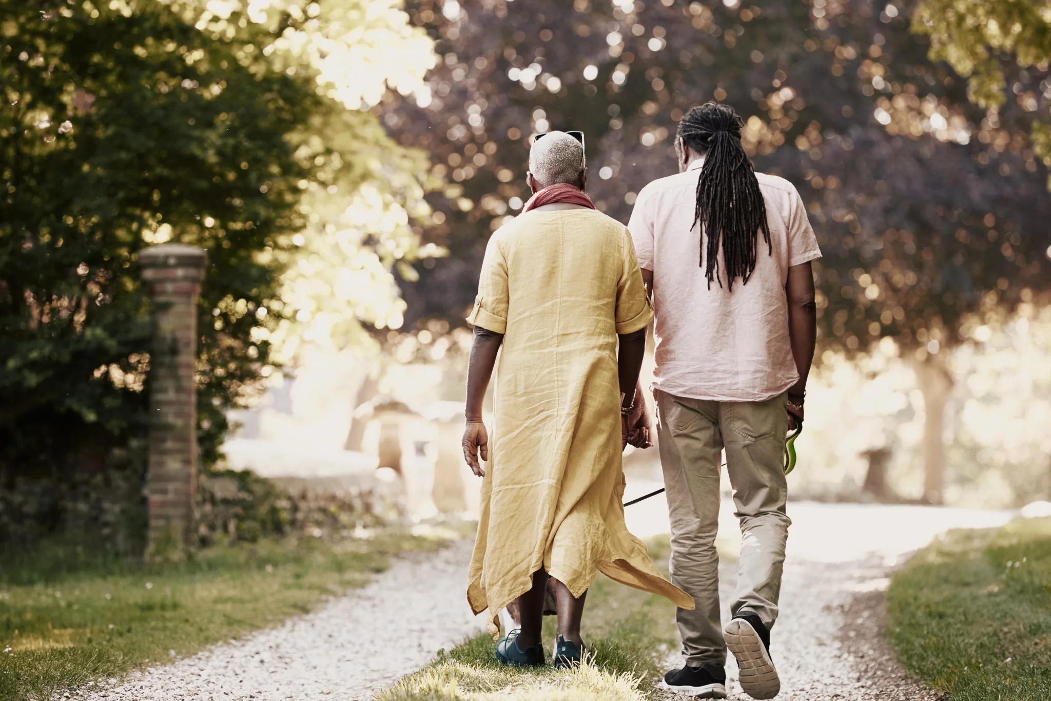 Senior couple walking their bulldog in the countryside