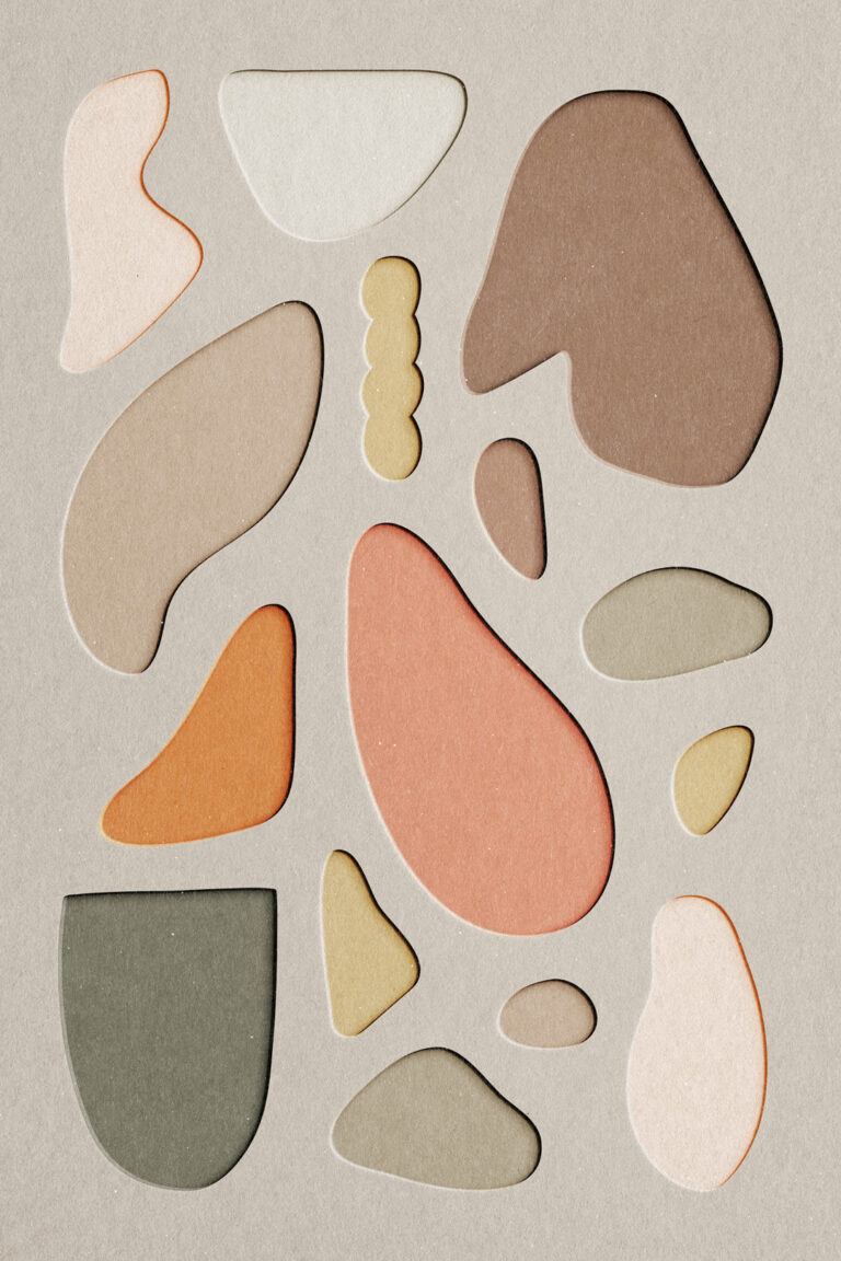 Abstract Image of papercraft cut out in beige, orange, olive cream - all different shapes.